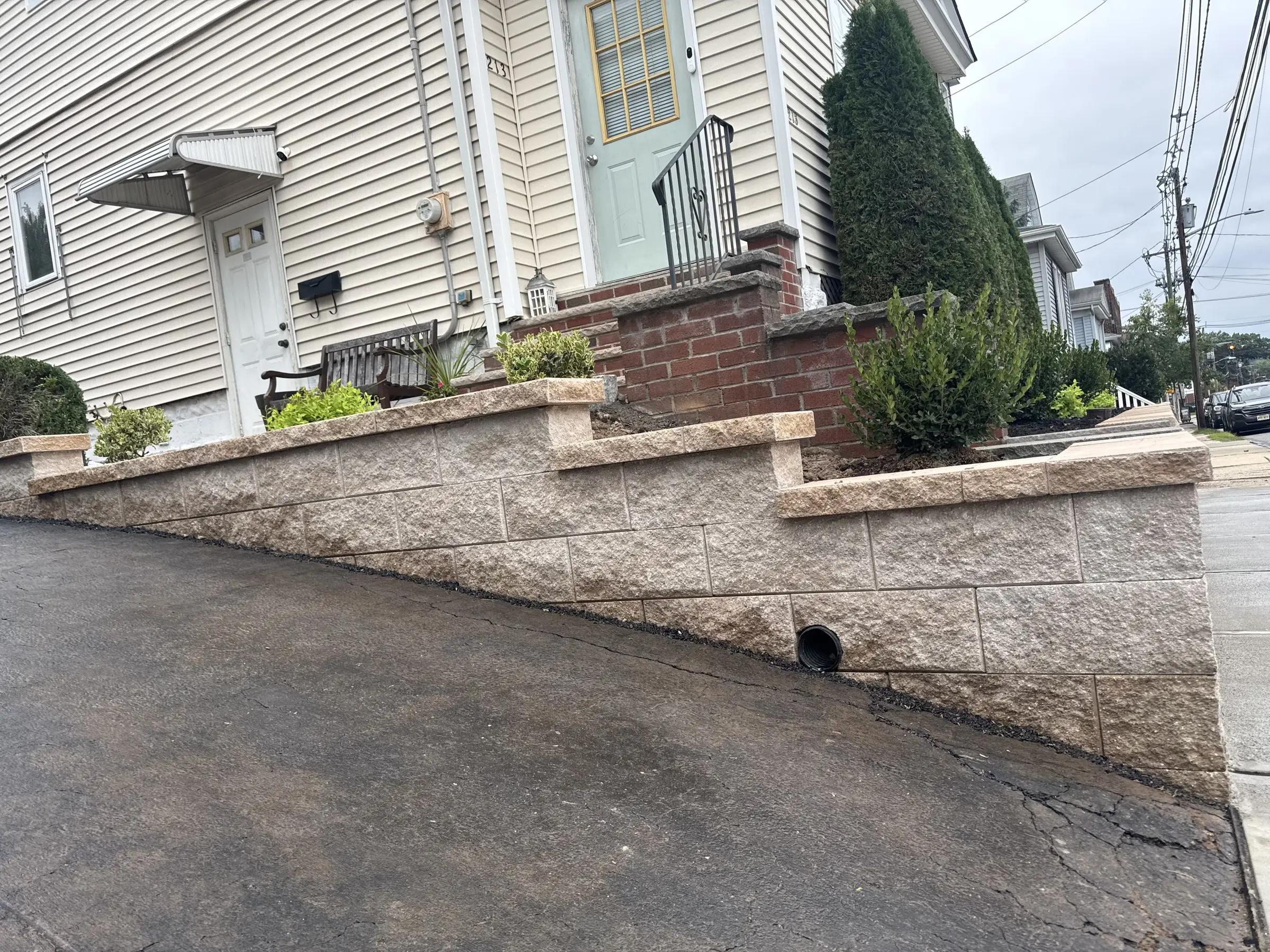 Stepped block wall with plantings above a driveway