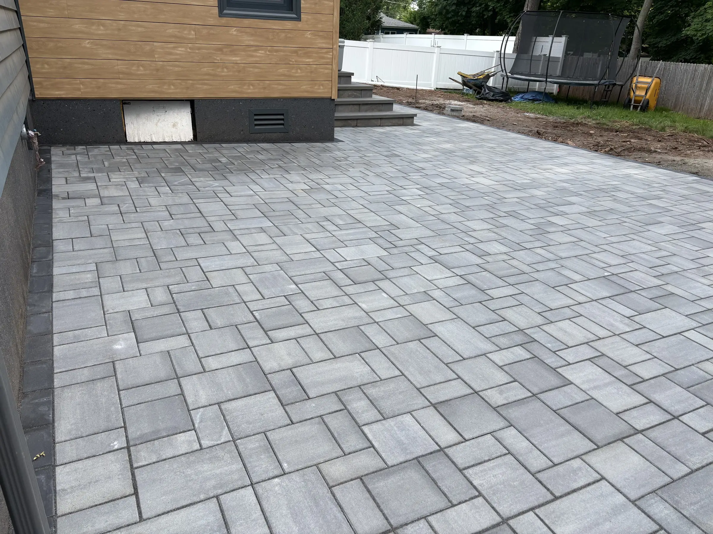Finished paver patio behind a Northern New Jersey home