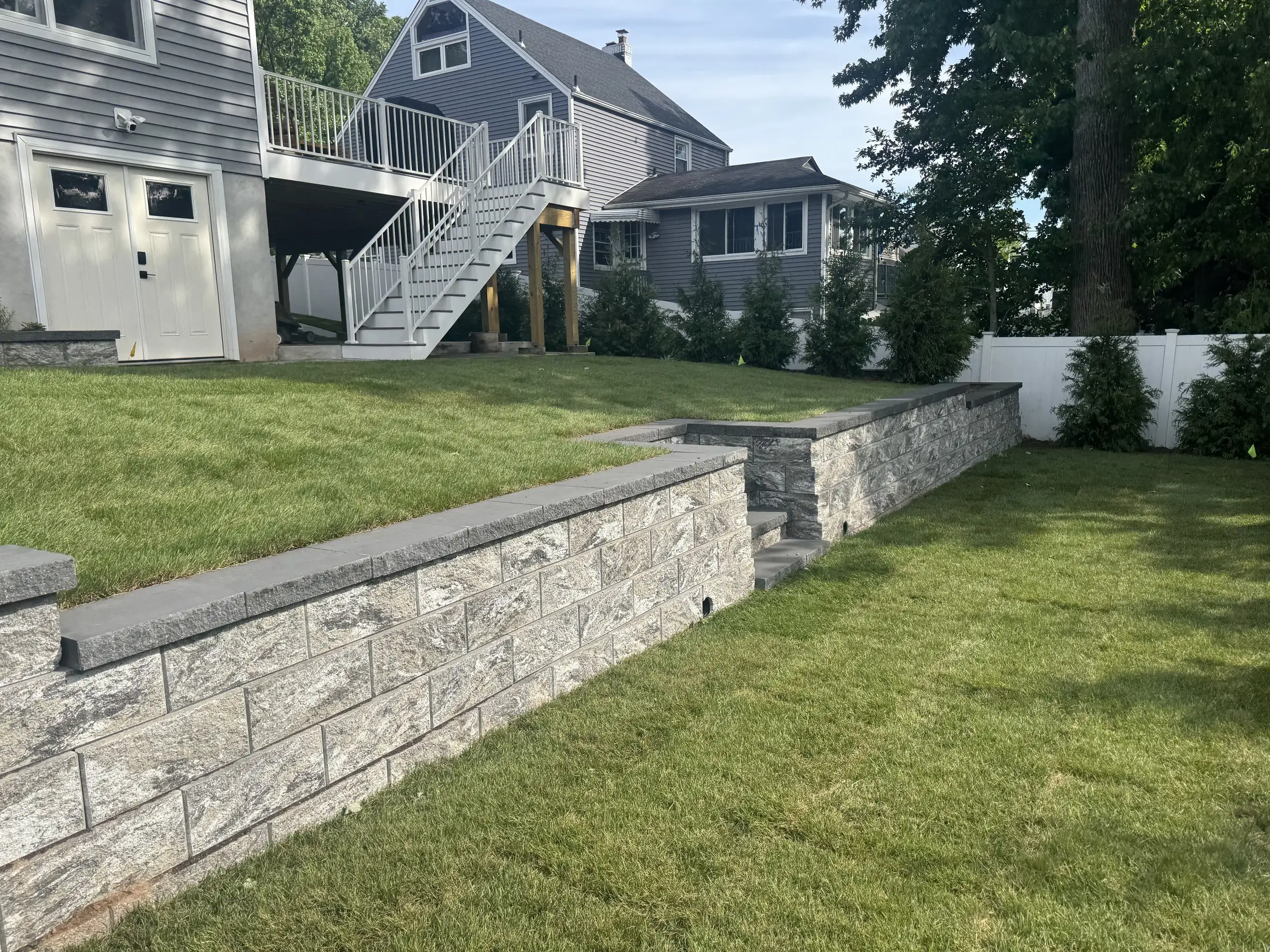 Stone retaining wall with steps built by JCM Construction
