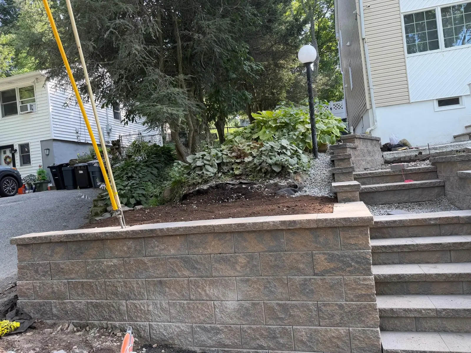 Stone retaining wall with steps to a patio