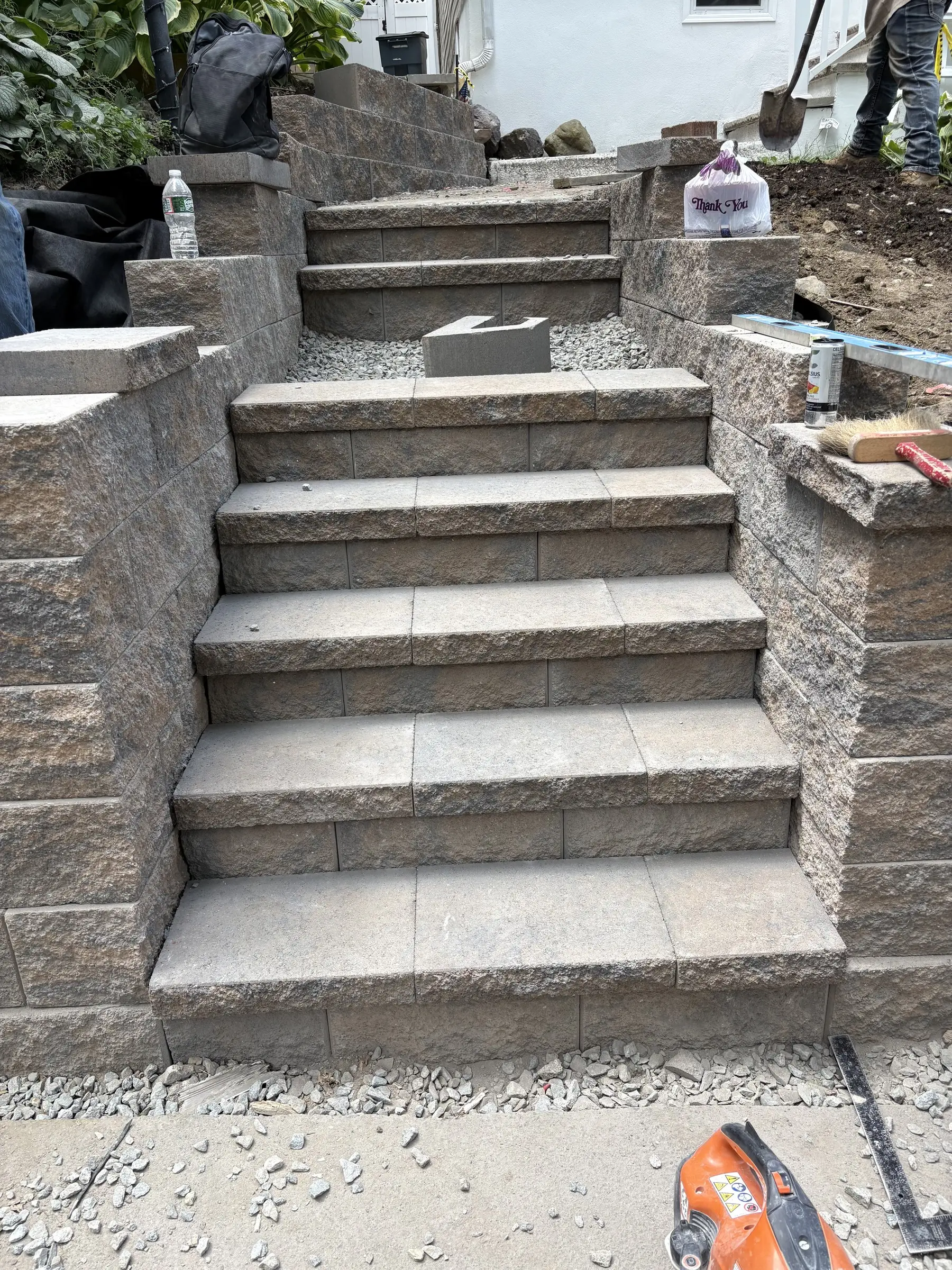 Stone steps with a wall and pillar under construction